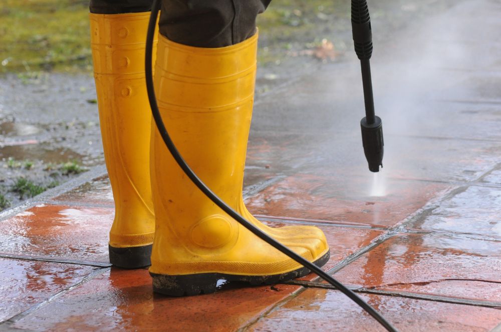 Pressure washing outdoor pavement