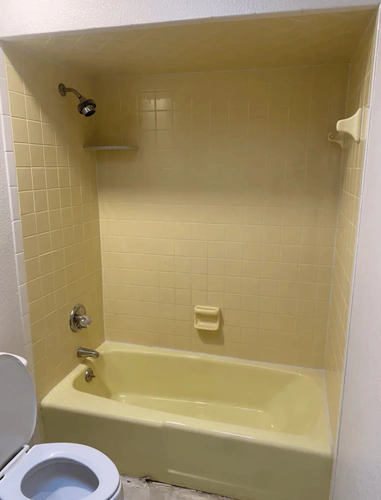 Daytona Beach bathroom before refinishing, with a butter yellow bathtub and matching yellow square tile surround and soap dish