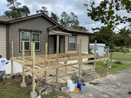 New pressure treated deck framing and posts in front of a Port Orange manufactured home, before any decking or stain