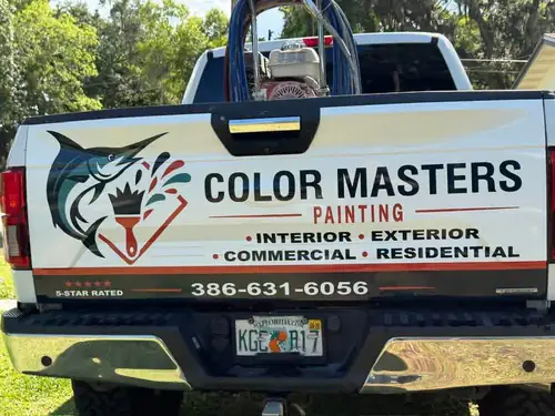 Color Masters Painting truck parked at Depot Park during the job, with a gas powered airless paint sprayer and blue hose in the bed